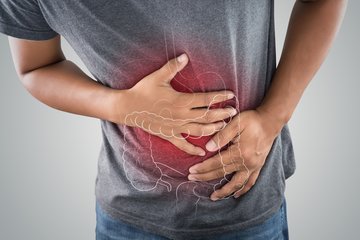 Ernährungsberatung - Hände reiben an schmerzender Stelle am Bauch